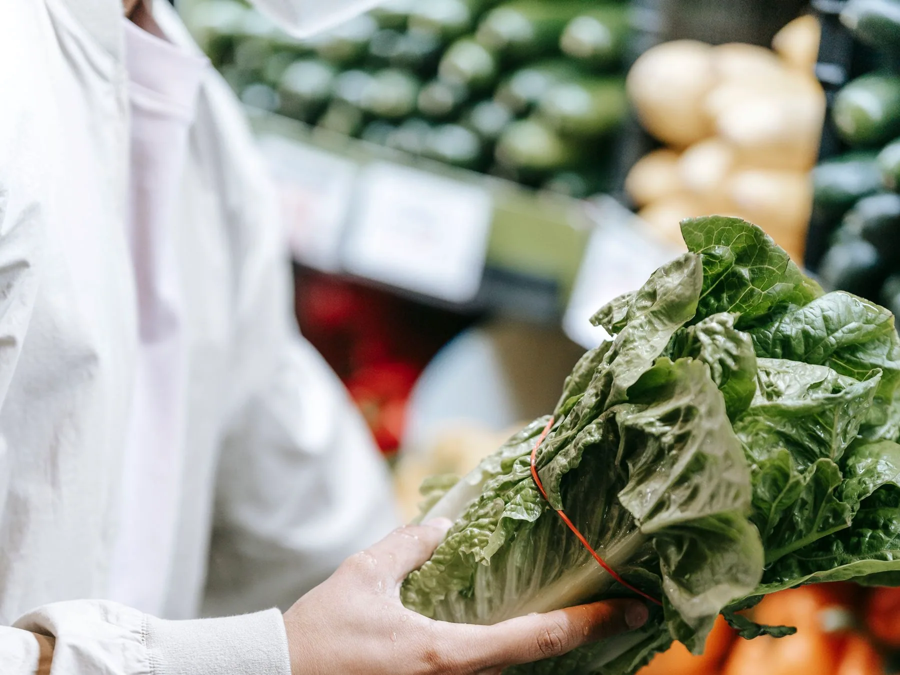 A shopper choosing greens